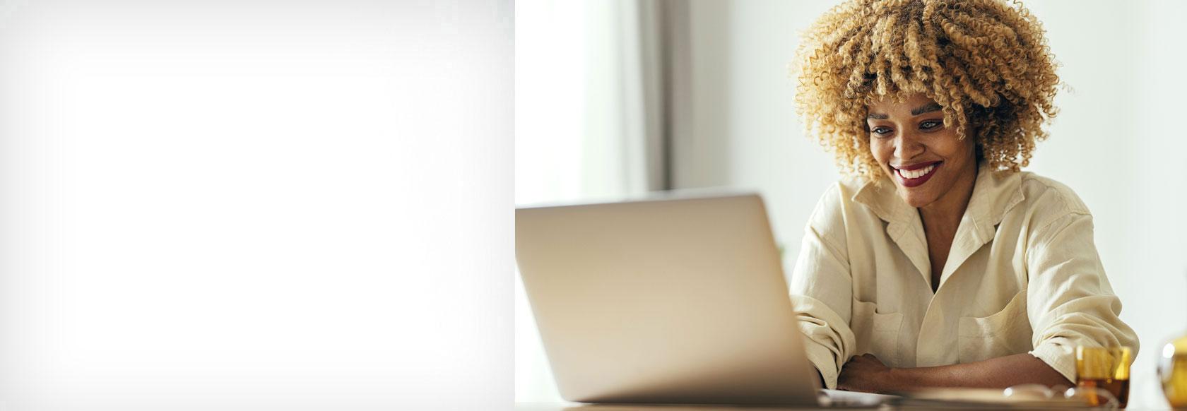 African American woman viewing laptop